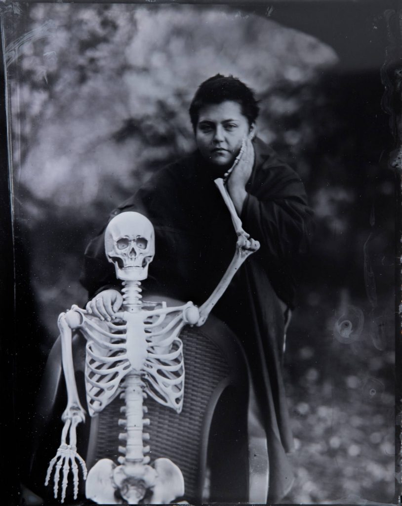 Halloween tintype of a model with a skeleton
