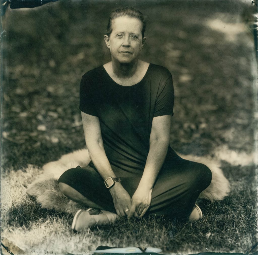 tintype of woman sitting on the grass