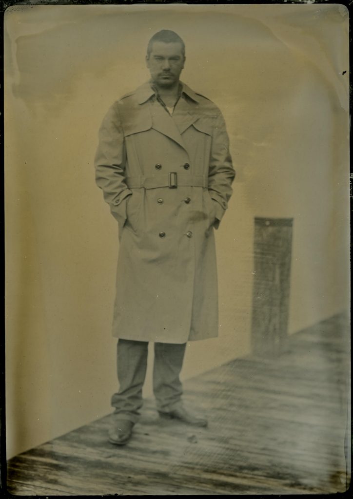 tintype portrait of a male model in a trench coat
