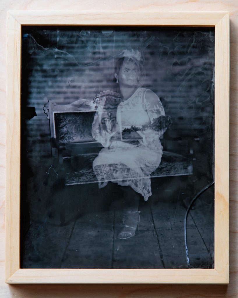 Ambrotype wet plate collodion image of a seated woman in a dress