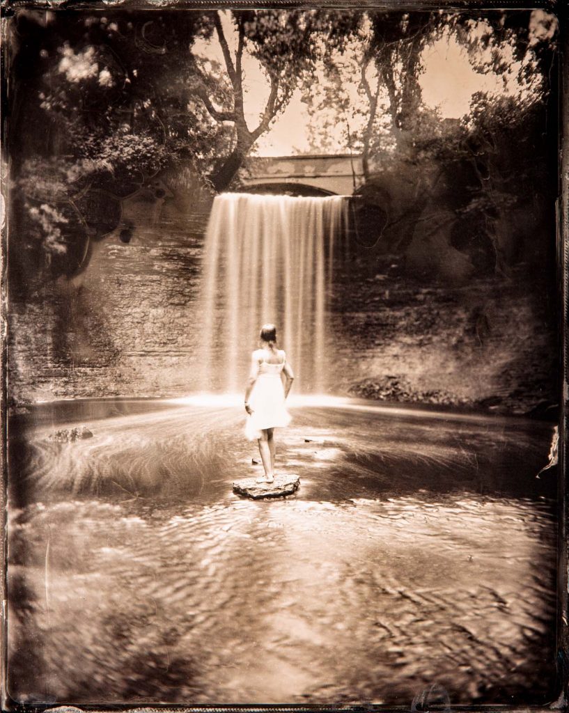 tintype portrait of a model in front of a waterfall