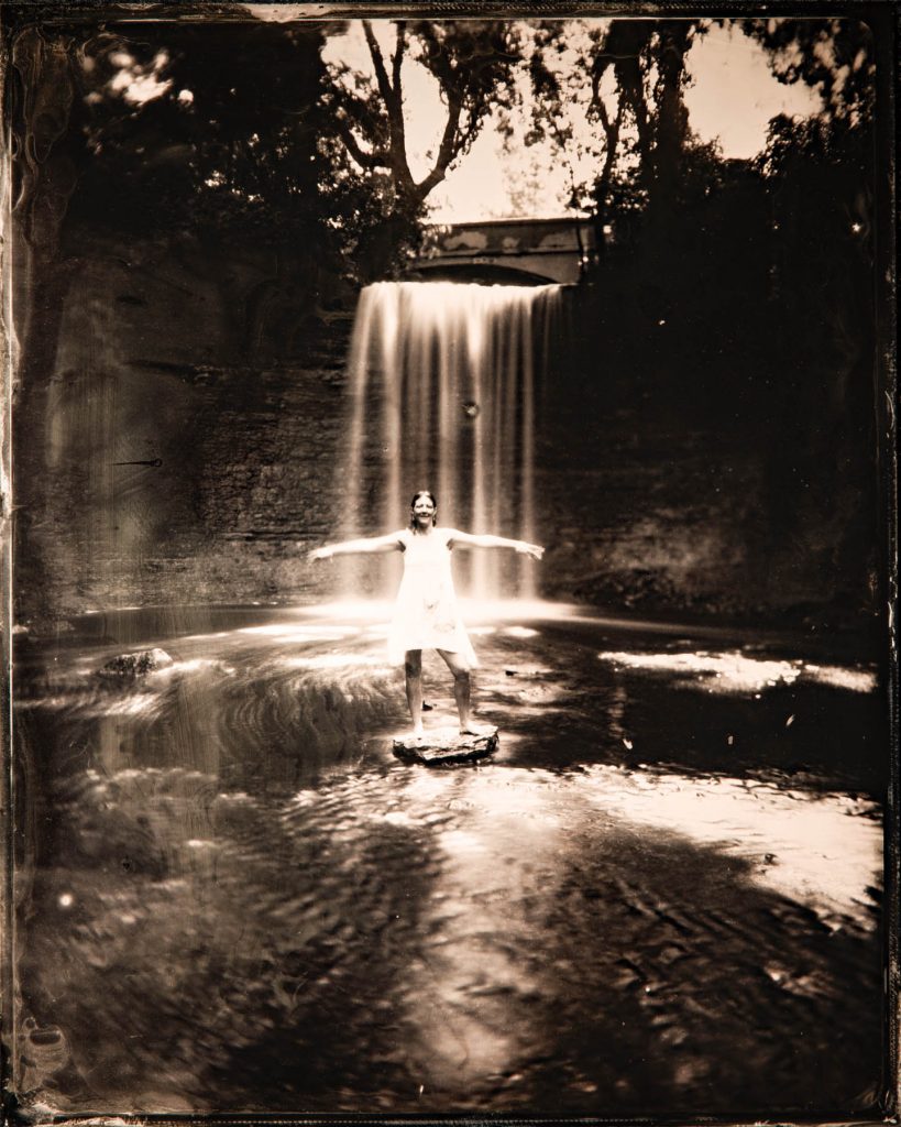 model in front of a waterfall - tintype