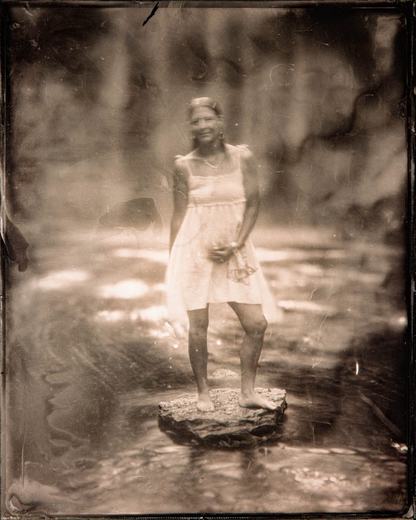 model in front of a waterfall - tintype