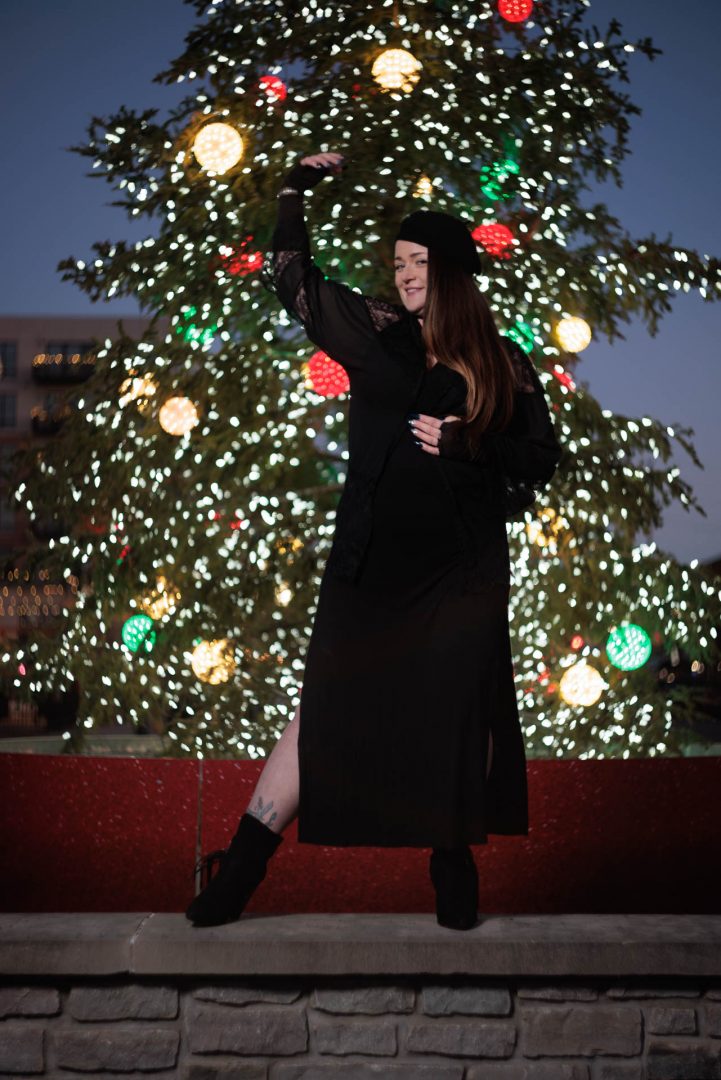 Female model in front of a Christmas tree