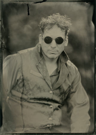 Gothic young man in sunglasses in a tintype
