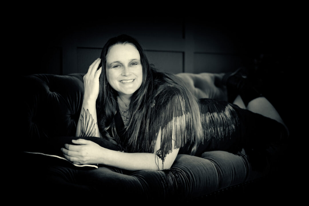 black and white portrait of a woman on an antique couch