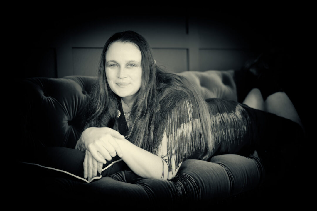 black and white portrait of a woman on an antique couch