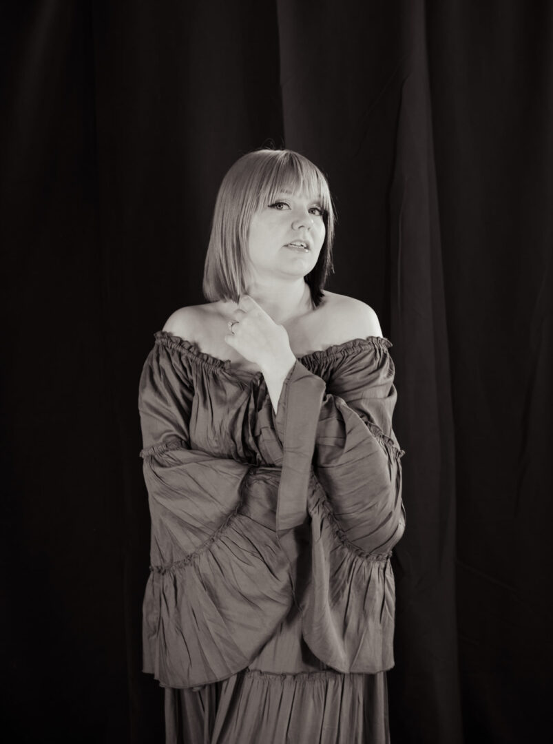 black and white portrait of a woman in a dark dress